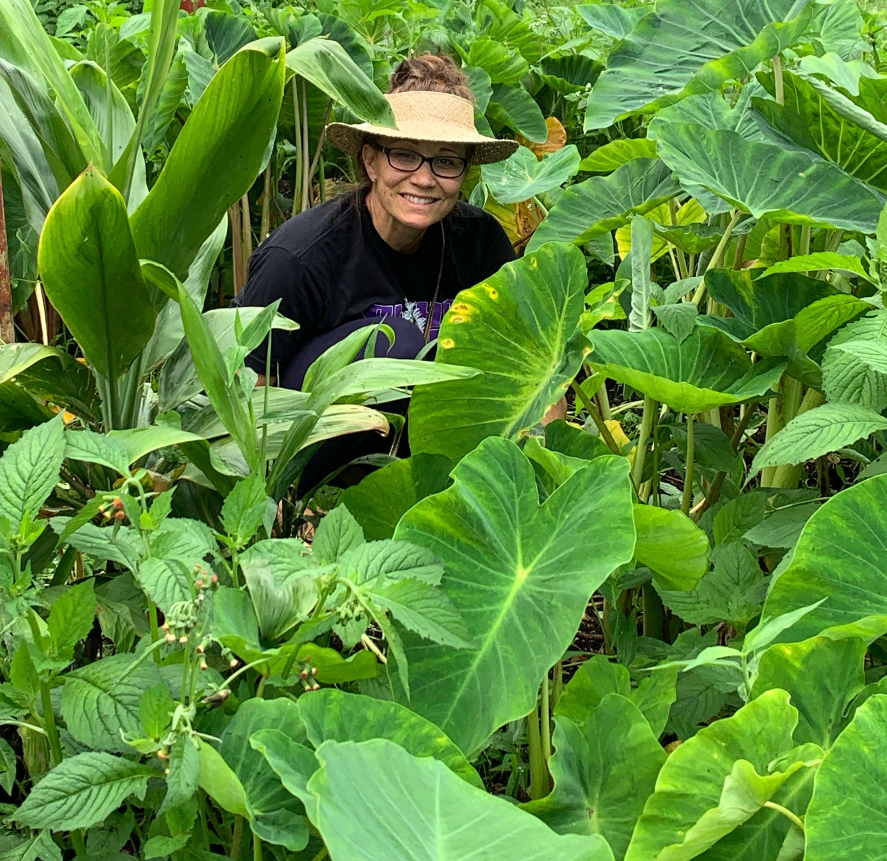 Kahelelani standing in the taro patch at the Keauhou farm